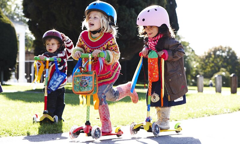 Kids enjoy playing a micro scooter game in the local park