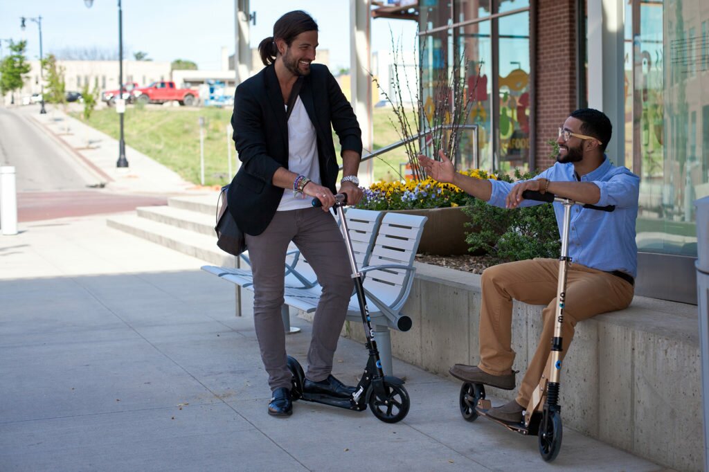 Commuters takes a break while scooting on Micro suspension scooters